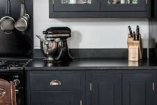 a black kitchen with black countertops
