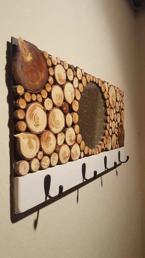 a creative clothes rack with tree slice decor and metal hooks is a stylish and cute rustic decor idea