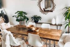13 a boho dining room with a hairpin leg dining table, white chairs, a hairpin console table, potted greenery, a mirror with a catchy frame