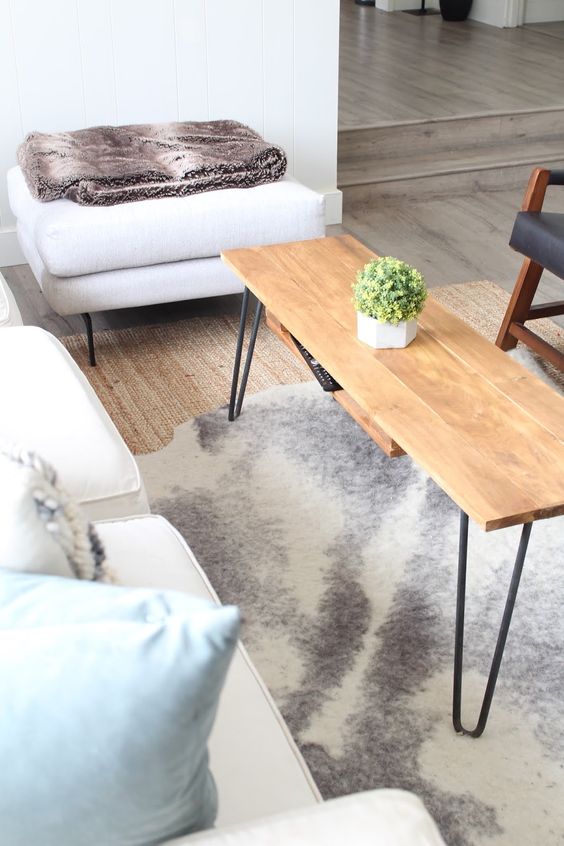 A cool and functional hairpin leg coffee table with an additional hidden shelf is a perfect solution for a boho or mid century modern space