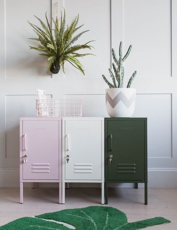 An arrangement of pink, creamy and dark green lockers is a stylish storage idea for any space, and the colors will add eye catchiness