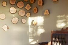 21 a creative and cool wall art of tree slices going from one wall to another is a cool and beautiful decor idea in rustic style