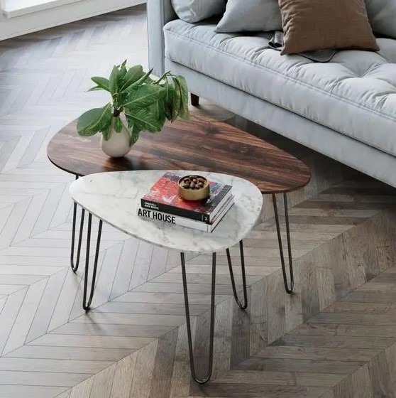 A duo of mid century modern coffee tables, with a rich stained wood and white stone tabletops and hairpin legs is cool