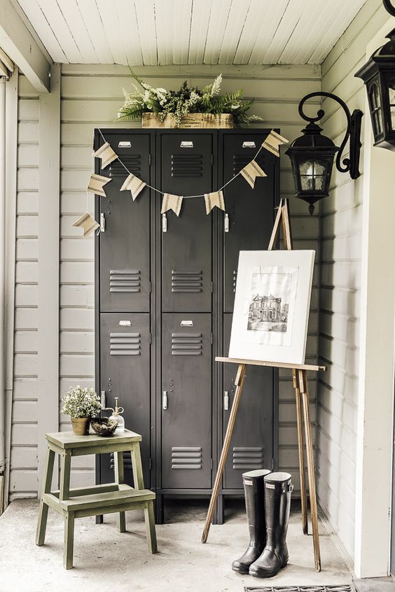 A porch with graphite grey lockers, a ladder, an artwork, greenery, buntings and rubber boots   store outdoor stuff in these lockers