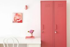 26 a cool home office with a creamy desk and a locker for storage, coral lockers for storage and some pink and coral art