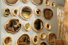 28 a whole gallery wall of tree slices and mirrors inside them is a modern take on classic rustic decor and it looks spectacular
