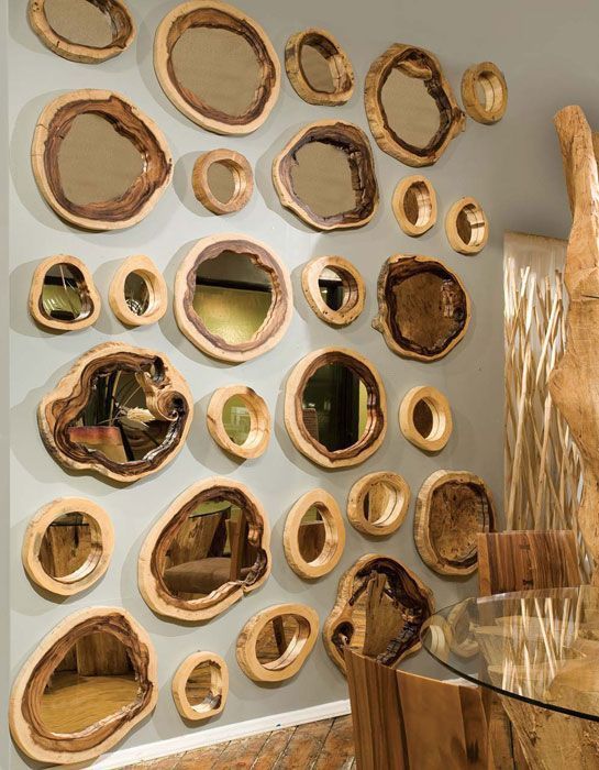 a whole gallery wall of tree slices and mirrors inside them is a modern take on classic rustic decor and it looks spectacular