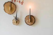 29 a wood slice home wall art with a branch, some feathers and a candle will fit a boho or eclectic space easily
