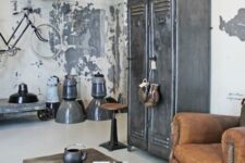 31 a shabby chic industrial interior with metal lockers, a leather chair, a coffee table on casters, metal pendant lamps and a bike on the wall