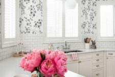 34 a white farmhouse kitchen with only lower cabinets, white stone countertops, a white subway tile backsplash and floral wallpaper