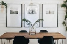 35 a Scandinavian dining room with a hairpin leg dining table, stylish black chairs, a gallery wall and some greenery around
