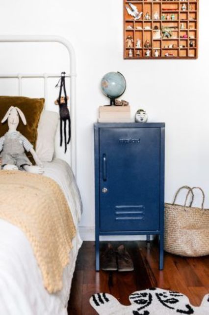 a small navy locker as an alternative to a nightstand, it's a great storage piece that is practical and will add a touch of color