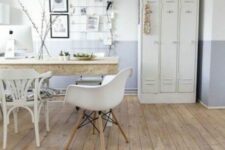 53 a Scandinavian home office with creamy lockers, a large desk, white chairs, a grid memo board and some art