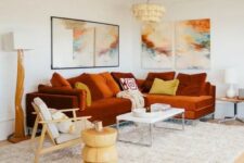 a bold living room with a rust-colored modern sectional and a bright gallery wall plus statement lamps