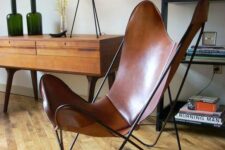 a brown leather butterfly chair is a cool mid-century modern addition to any space, it looks elegant and chic