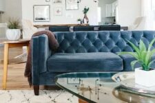 a farmhouse boho space with a muted blue velvet Chesterfield sofa that works as a space divider, too