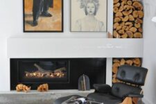 a fireplace nook with a built-in fireplace, firewood storage, a black Eames lounger and ottoman, a rug and a mini gallery wall