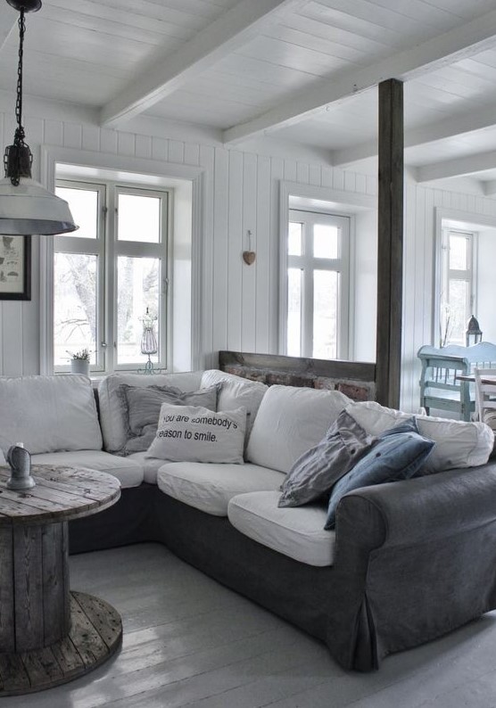 a graphite grey leather sofa cover with white cushions is a perfect match for a Scandinavian interior