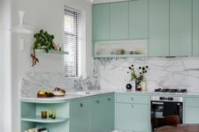 a mint blue kitchen with flat panel cabinets, a white terrazzo floor and a white marble backsplash, a stained dining set