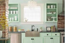 a mint farmhouse kitchen with shaker and open cabinets, a blue beadboard wall, black fixtures and black knobs