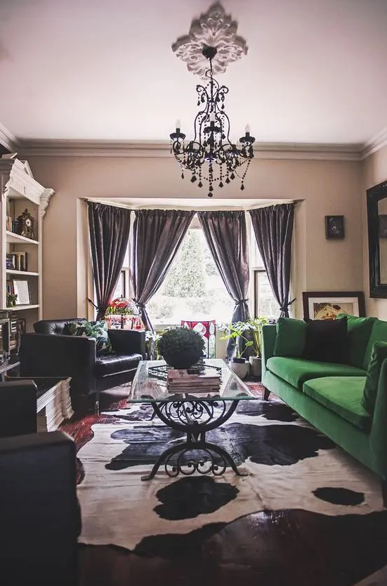 A moody living space with a bold splash   an emerald green velvet Stockholm sofa that makes a statement
