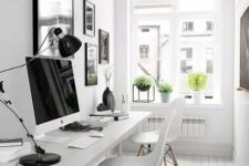 a lovely b&w home office with a b&w gallery wall