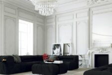 a refined white living room with molding and a vintage fireplace, a low black sectional and an ottoman plus a matching black daybed