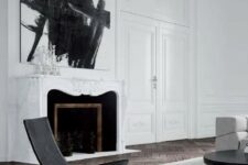 a white marble-clad French fireplace with black inside is a beautiful and refined addition to the living room