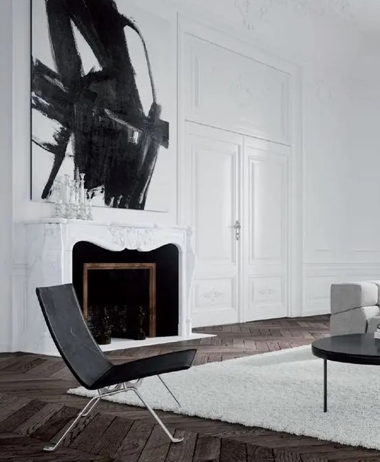 A white marble clad French fireplace with black inside is a beautiful and refined addition to the living room
