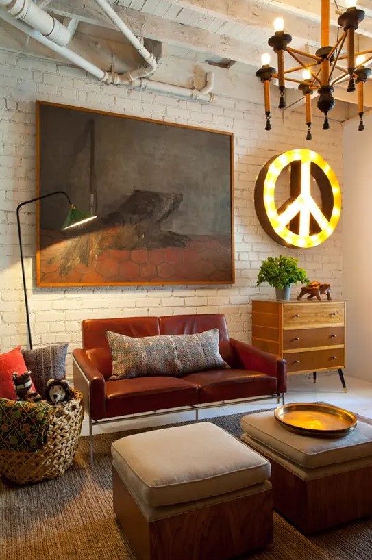 An eclectic living room with industrial touches, mid century modern furniture and creative artworks