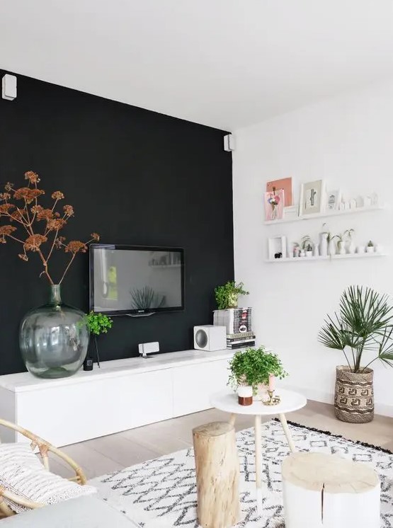 a Scandinavian space done in neutrals and creamy shades, and one black wall for a bold accent, some boho touches