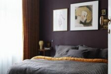 13 a refined and chic moody bedroom with a deep purple accent wall, a bed with grey bedding, nightstands, some artwork and mustard curtains