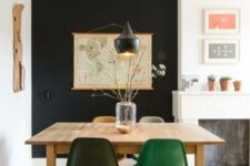 16 a cozy dining space with a black accent wall, a stained table and colored chairs, a black pendant lamp and a map on the wall