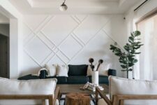 22 a stylish living room with a white paneled wall that makes an accent and looks bold adding style and chic to the space