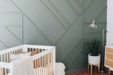 23 a welcoming rustic boho nursery with a green paneled wall for a chic and stylish statement plus a touch of natural color