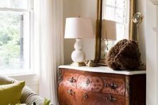 33 a beautiful ornate stained sideboard with a white stone countertop, a large mirror and a chic table lamp are a great combo for a living room