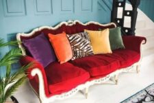 34 a bright eclectic entryway finished off with a bold vintage red sofa that stands out and colorful pillows