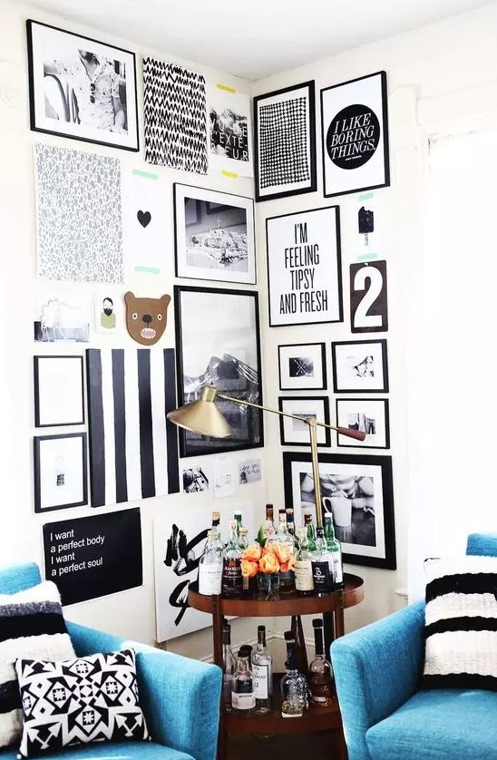 a bold corner gallery wall in black and white, with prints, artwork, photos and fun pieces is a cool idea for a modern space