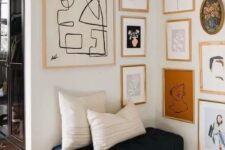 49 a chic gallery wall with gold and blonde wood frames and abstract art of various kinds