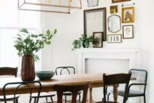 56 a charming vintage dining room with a vintage table and mismatching chairs, a faux fireplace and a mini gallery wall over it