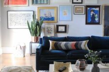 59 a catchy living room with a navy sofa and bright pillows, a printed pouf and rug, a colorful gallery wall and potted plants