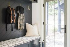an entryway with a dramatic black accent wall