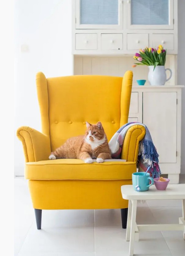 A bold yellow IKEA Strandmon chair will add a cheerful touch and plenty of color to your space making it more spring or summer like