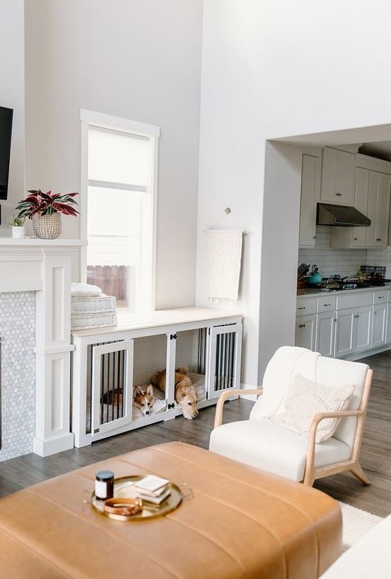 a built-in dog crate in white doubles as a console table is a cool idea and it perfectly matches the interior