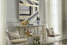 a chic and refined space with a tiered table as a home bar, ghost chairs, printed pillows, a geometric artwork and a fluffy rug