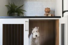 a dog crate built-in into a kitchen cabinet won’t prevent you from doing usual things while your pet is here