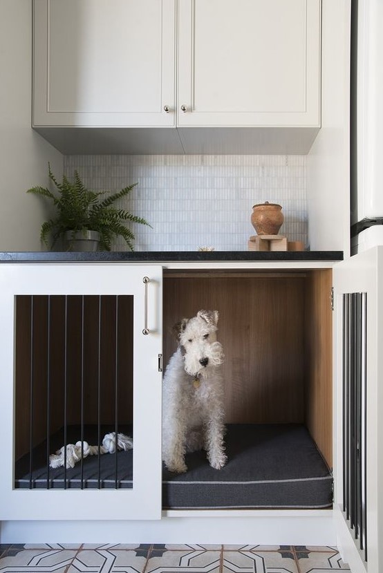 a dog crate built-in into a kitchen cabinet won't prevent you from doing usual things while your pet is here