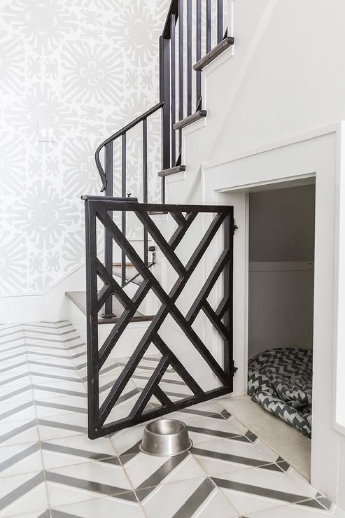a dog crate built into the space under the stairs is a cool idea that doesn't spoil the style of the space