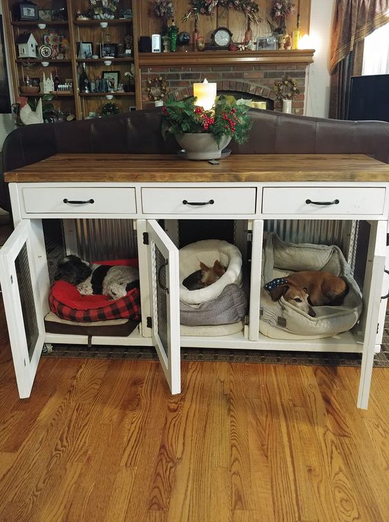 a farmhouse console table with built-in dog crates and a butcherblock countertop is a stylish piece