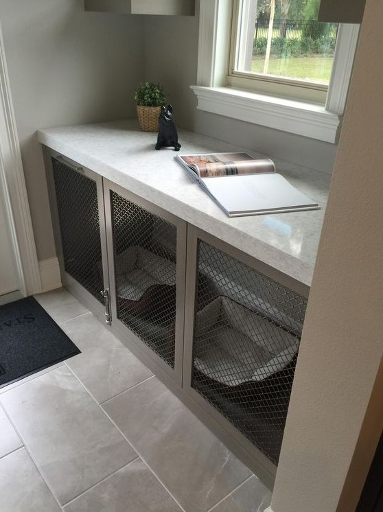 A mudroom console table with a built in dog crate with a couple of dog beds is a cool idea for a modern space